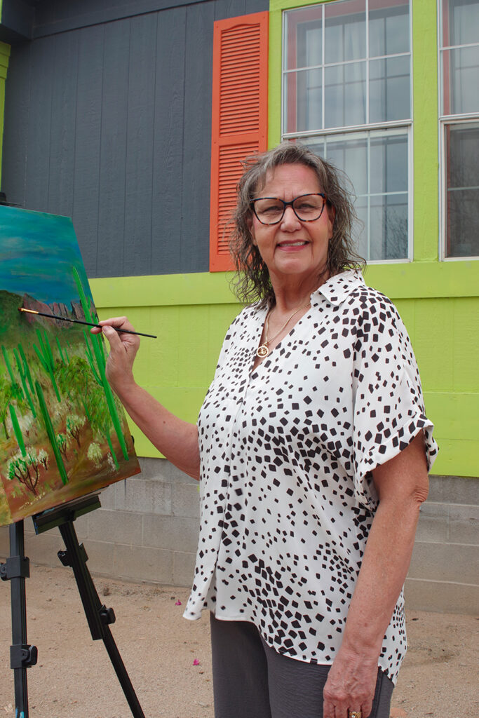 Picture of Julie Lunt Painting with easel.